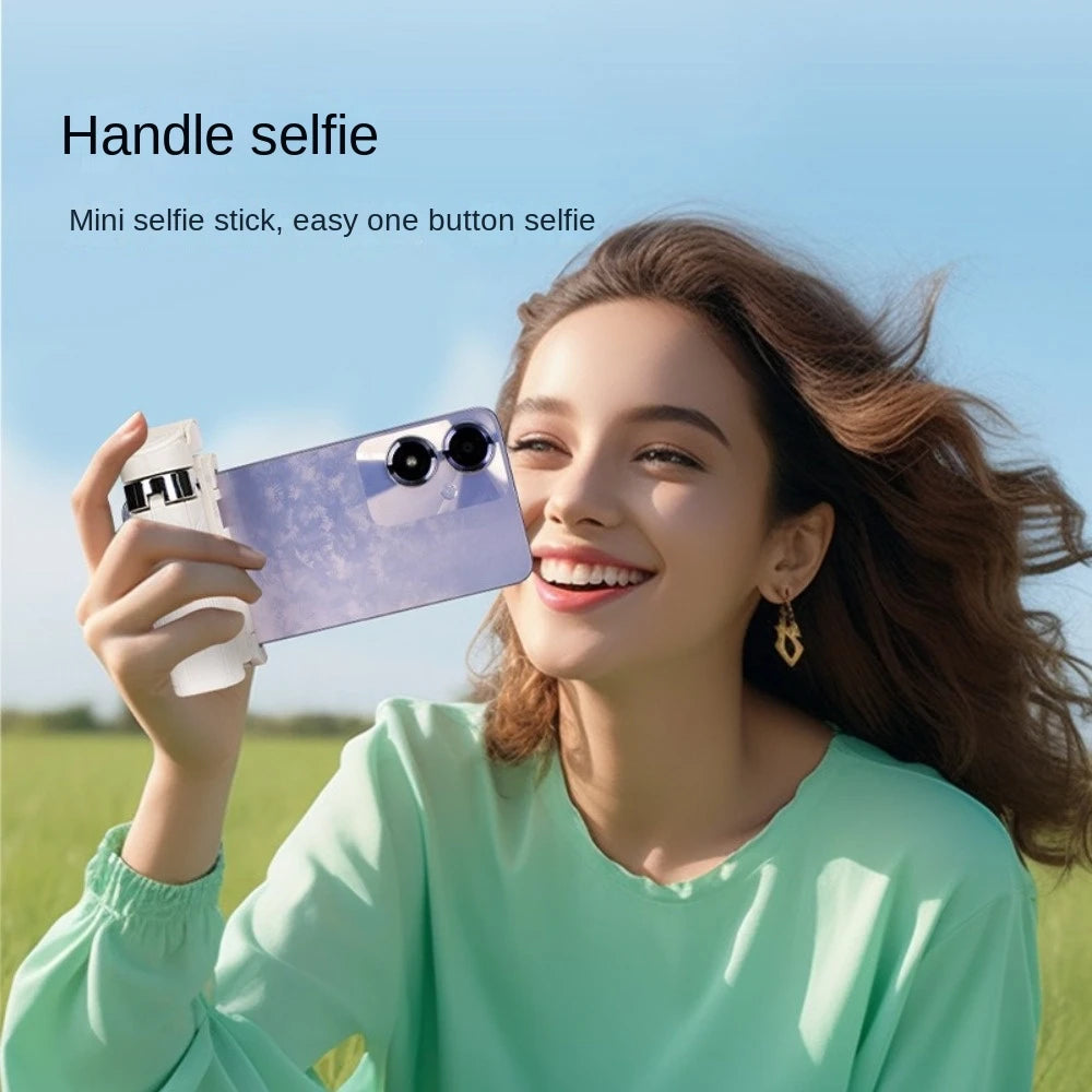 Woman taking a selfie with a mini selfie stick in an outdoor setting