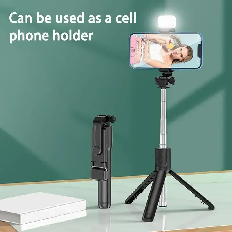 Phone holder with tripod and remote control on a green background