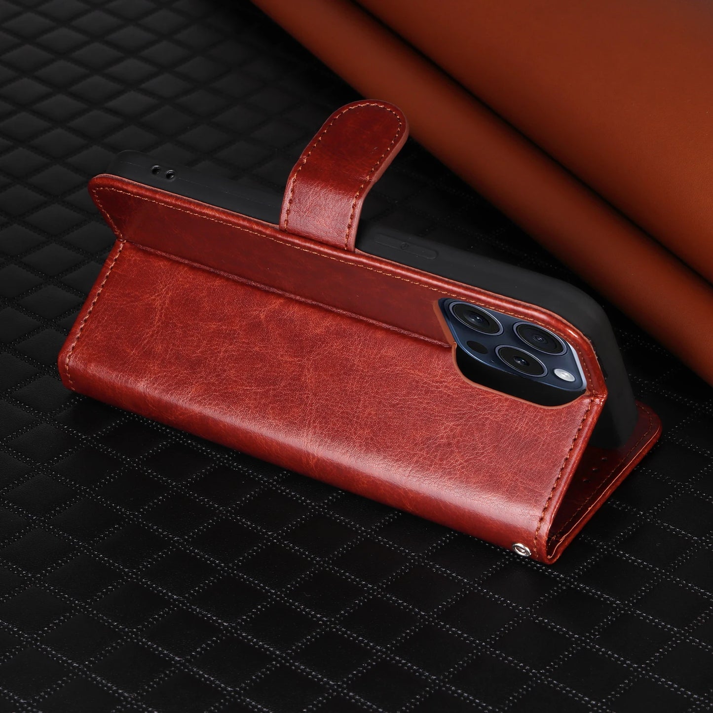 Brown leather phone case on a black textured surface