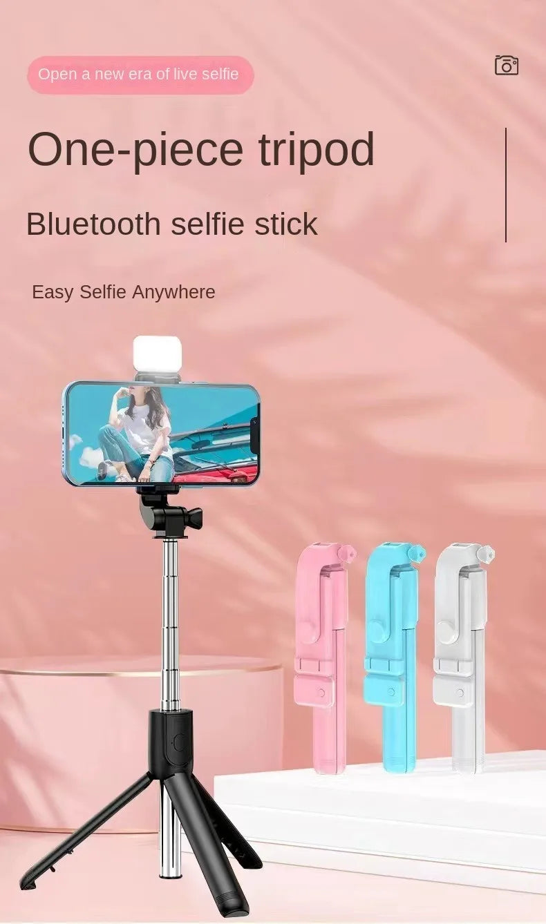 One-piece tripod Bluetooth selfie stick with smartphone on pink background