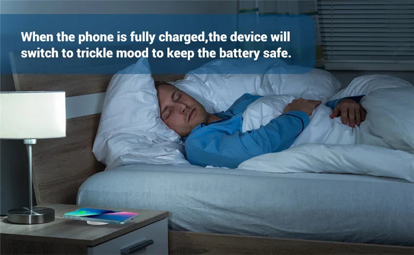 Man sleeping while iPhone charges on bedside table with magnetic wireless charger using trickle mode for battery safety.
