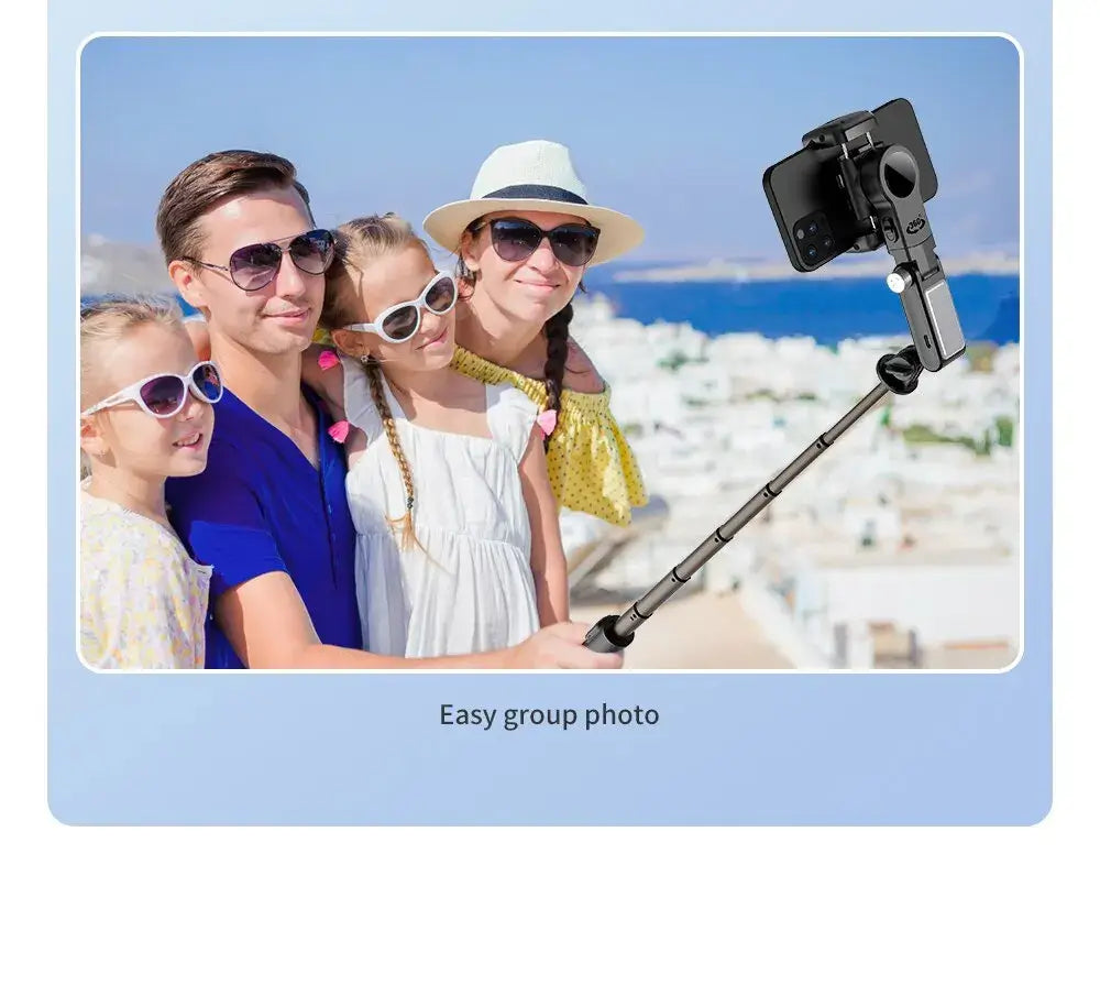 Family taking a photo with a selfie stick in a scenic location.