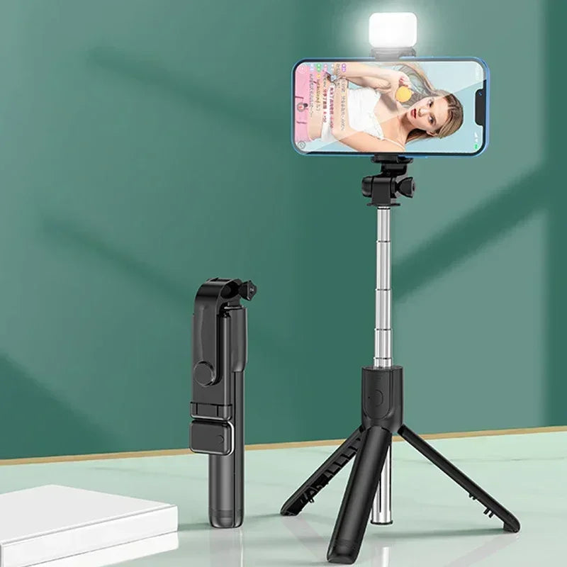 Smartphone with a selfie stick and light on a green background