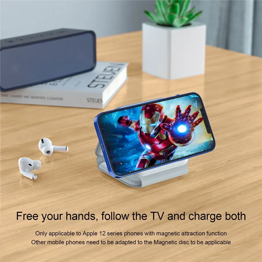 Smartphone with Iron Man app, wireless earbuds, and phone stand on a wooden table.