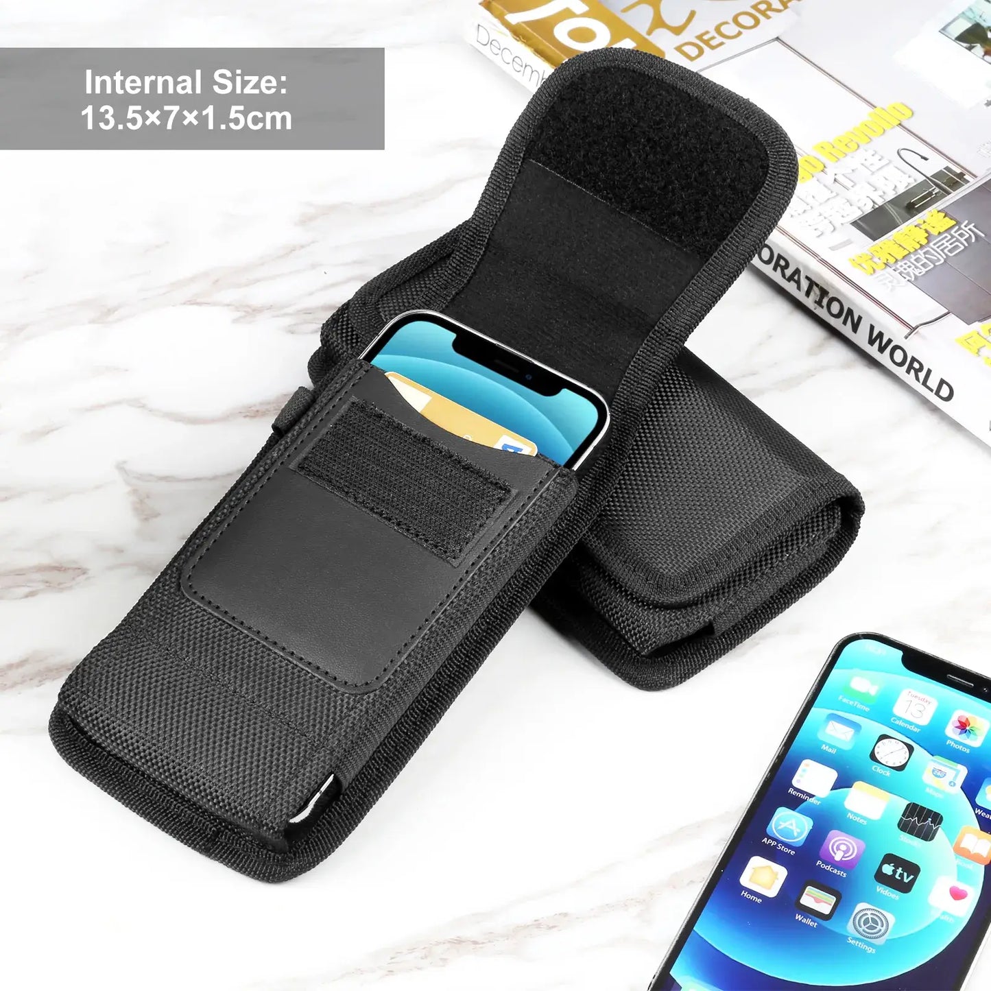 Black phone holster with internal size label on a white surface, with a magazine in the background