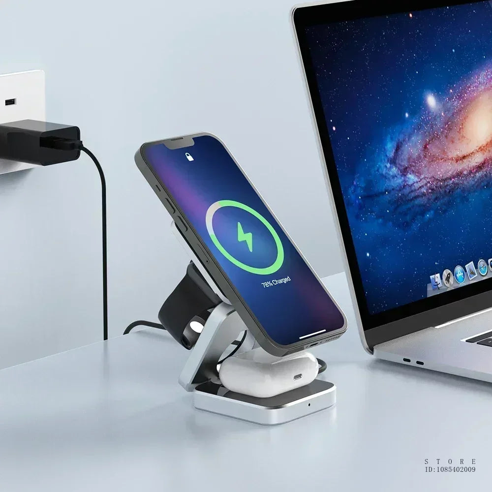 Phone on a charging stand next to a laptop on a light gray surface