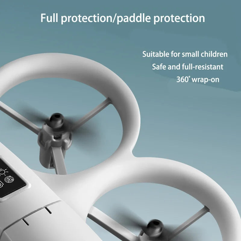 Close-up of a white drone with protective coverings on a light blue background, featuring text about protection and suitability for small children.