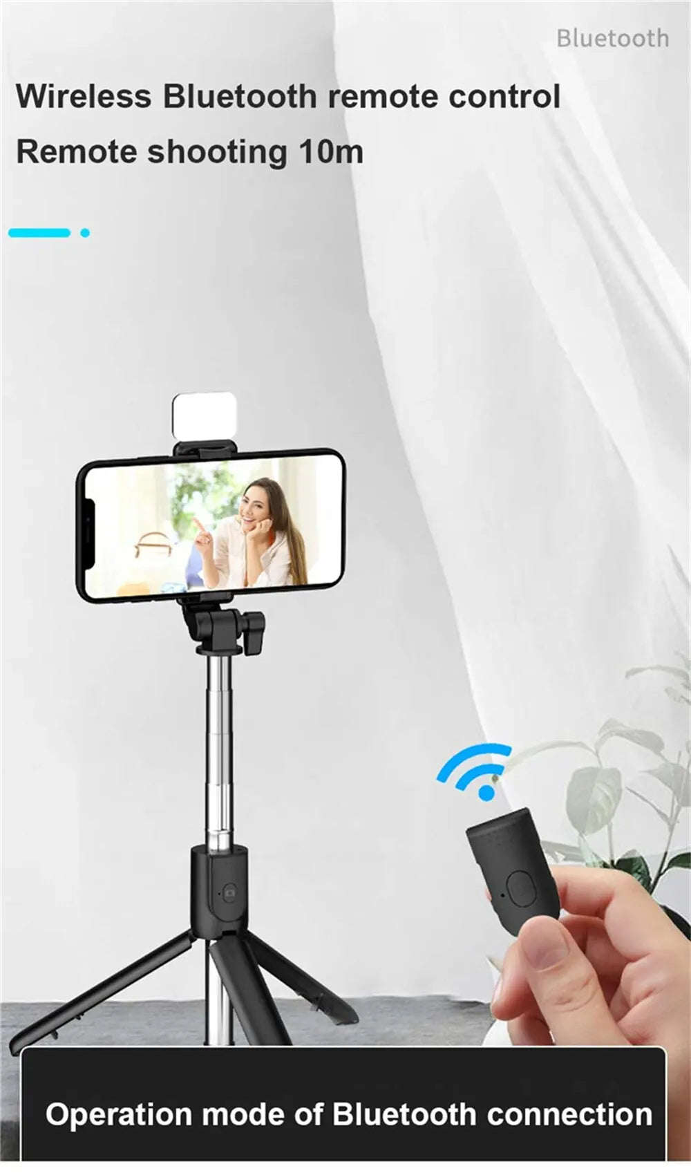 Wireless Bluetooth remote control with smartphone app on a tripod, held by a hand.