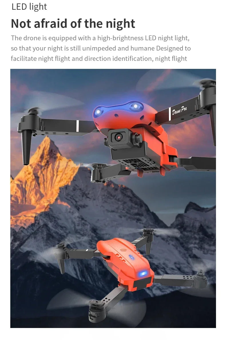 Red drone with LED lights against a mountainous background