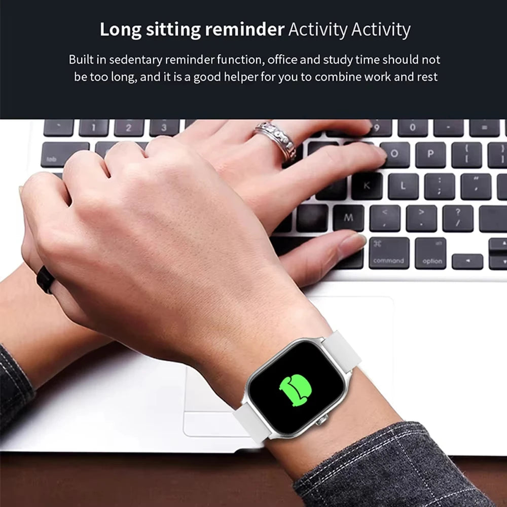 Smartwatch worn on wrist with keyboard in background, emphasizing activity reminder feature.