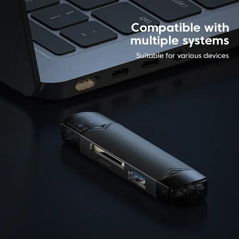 Black USB hub on a dark surface with text indicating compatibility with multiple systems