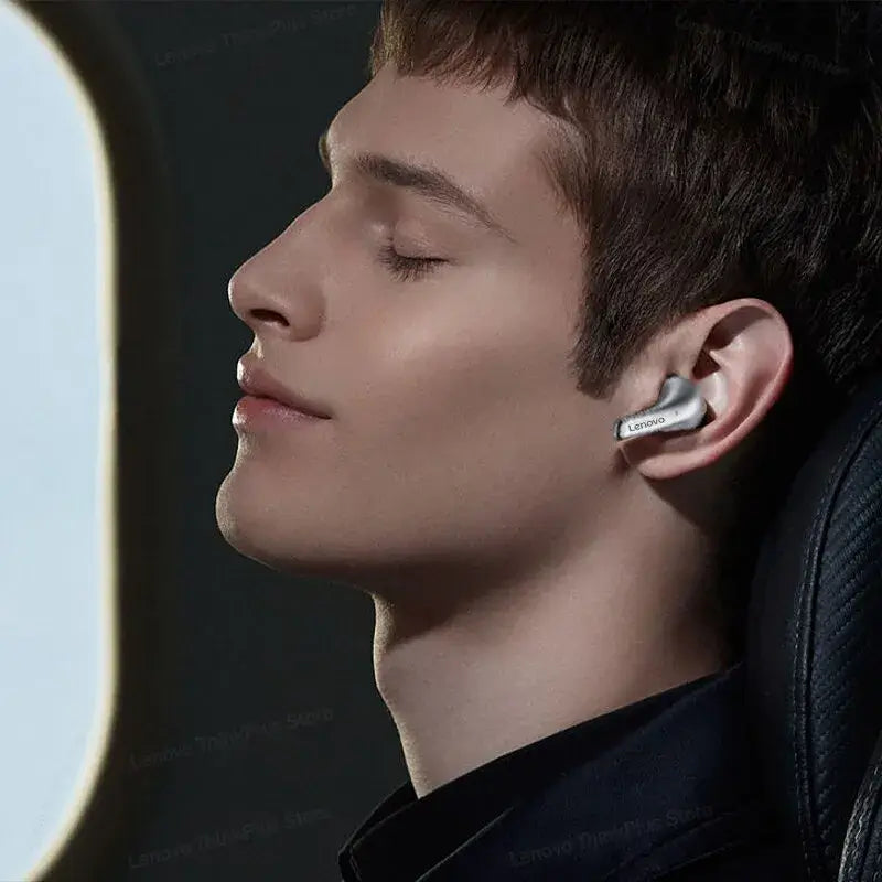 Person wearing a wireless earbud with a blurred background