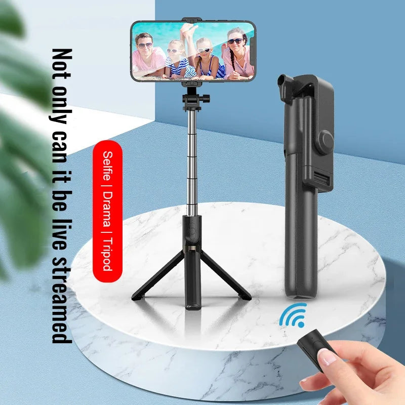 Smartphone with selfie stick and remote control on a white marble surface with blue background
