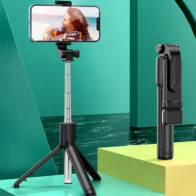 Phone holder with tripod and remote control on a green and yellow geometric background