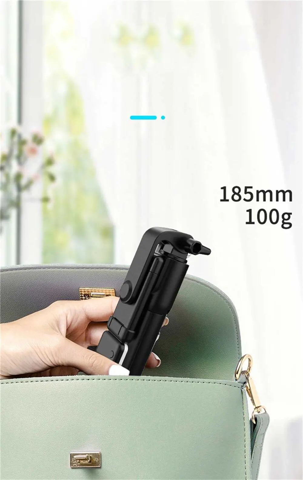 Hand holding a black camera tripod with measurements '185mm' and '100g' displayed.