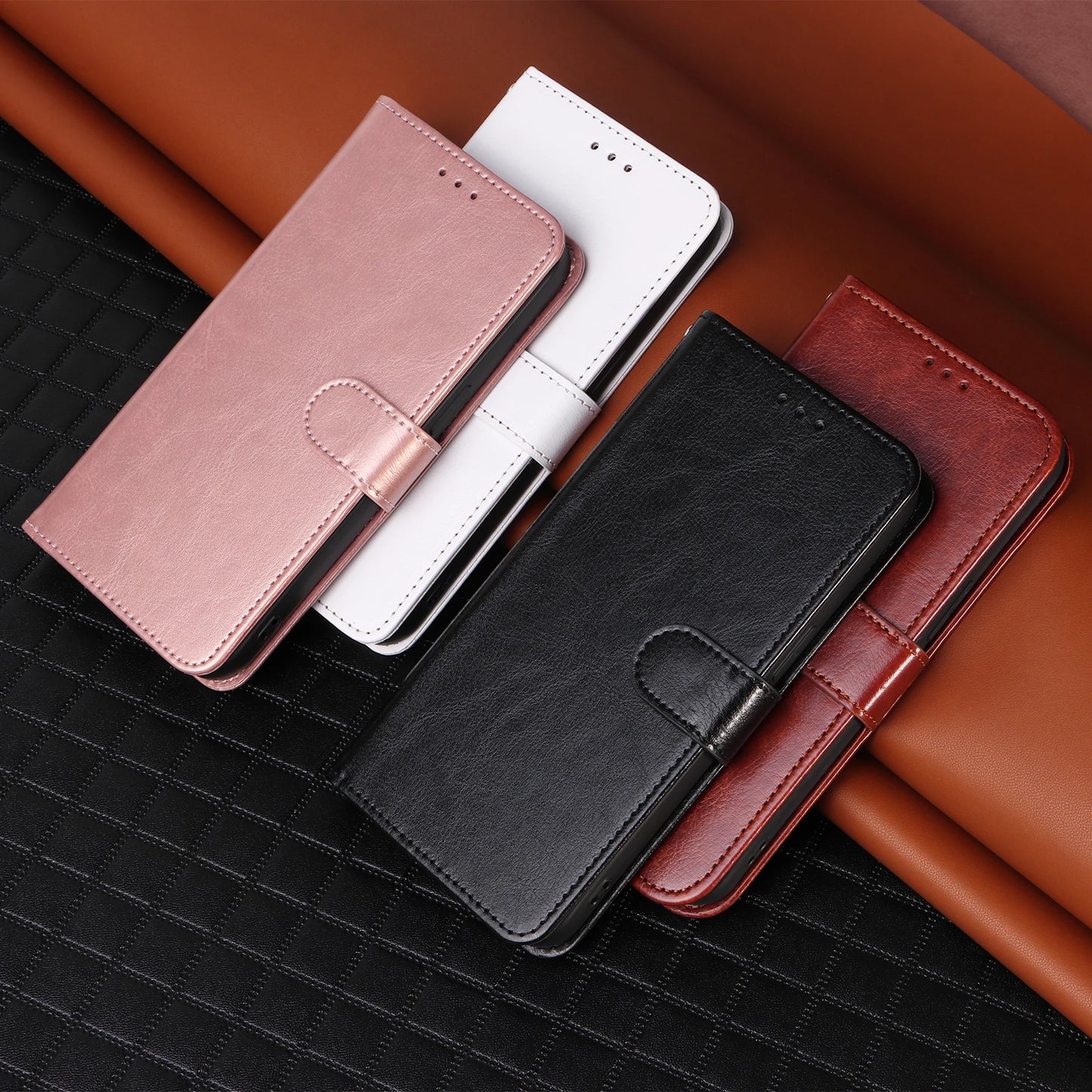 Four phone cases in different colors on a textured surface