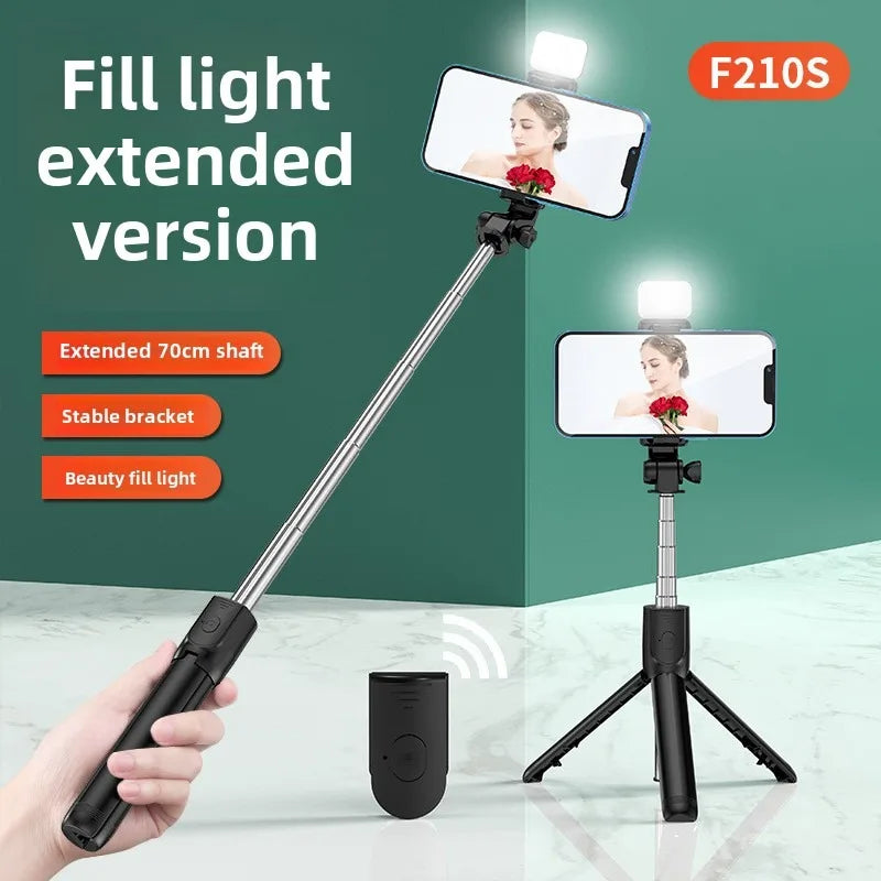 Handheld selfie stick with extended light and smartphone on a green background