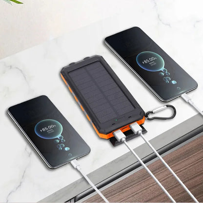 Solar power bank charging two smartphones on a marble surface