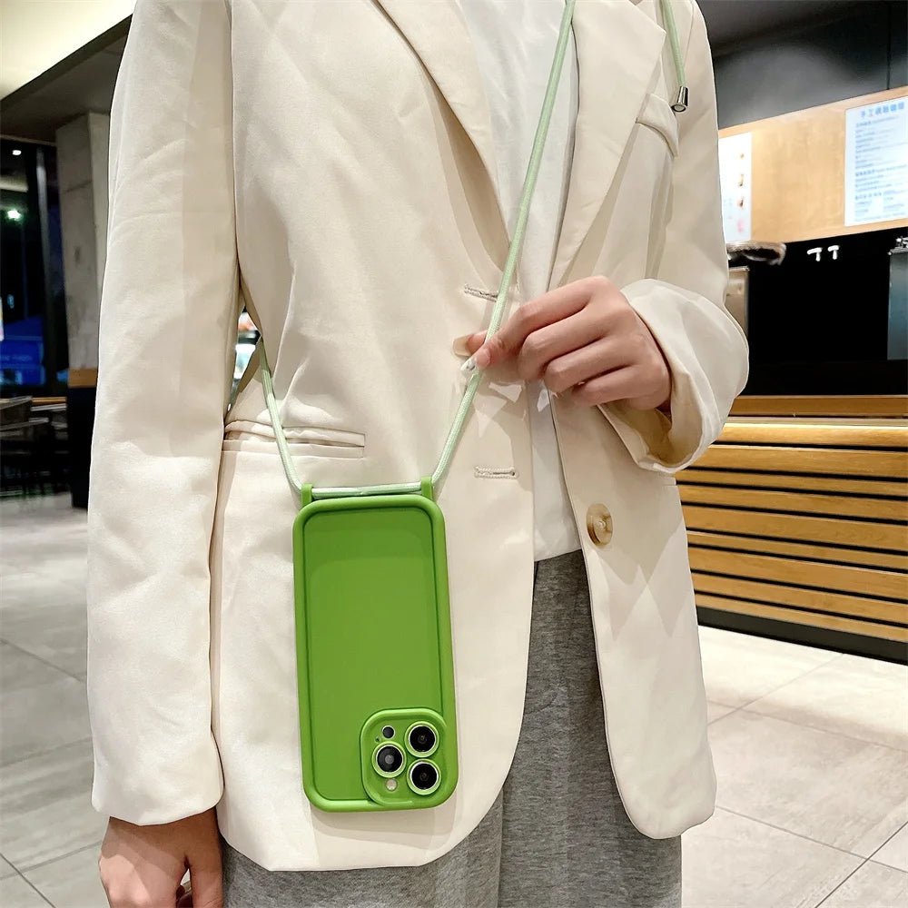 Person wearing a white coat with a green phone case on a strap.