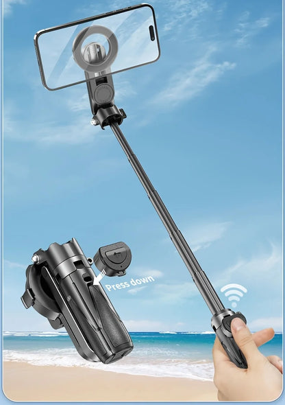 Handheld smartphone camera setup with a monopod against a beach background