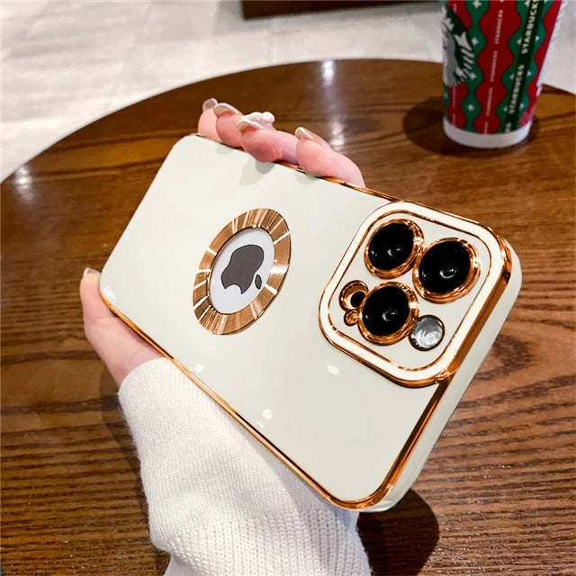 Phone case with decorative elements held by a hand on a wooden table