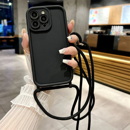 Black phone case with a strap held by a person in an indoor setting