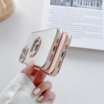 Phone case with rose gold trim held by a hand on a light surface.