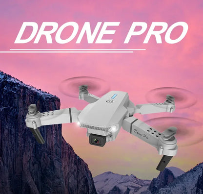 White drone with 'DRONE PRO' text against a mountainous landscape background