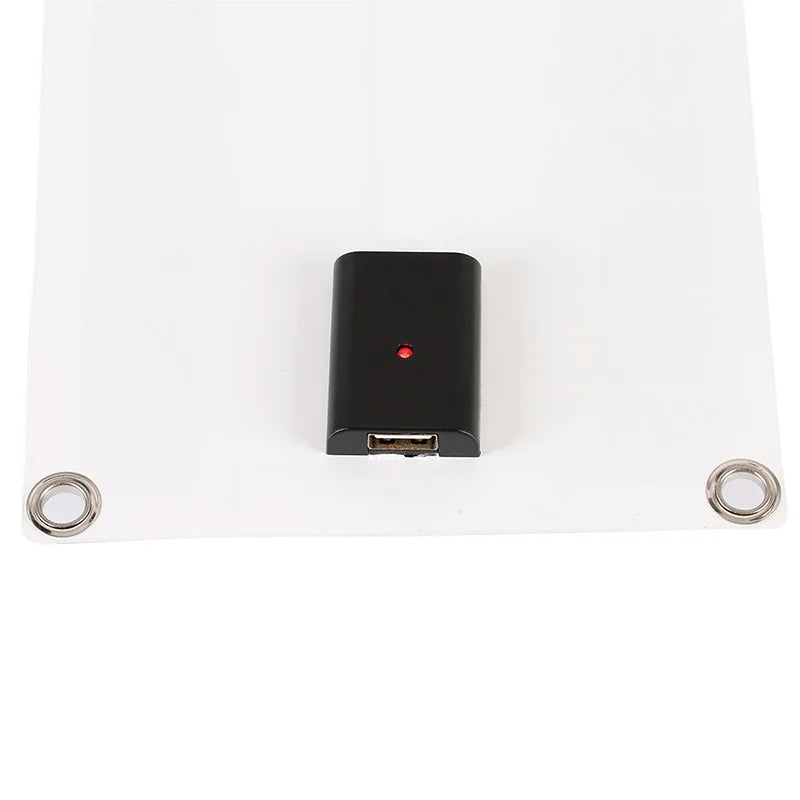 Black electronic device with a red light on a white background