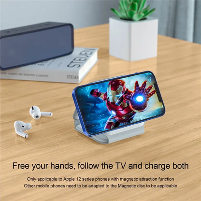 Smartphone with Iron Man app, wireless earbuds, and phone stand on a wooden table.