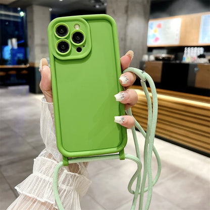 Green phone case with a strap held by a person in a blurred indoor setting