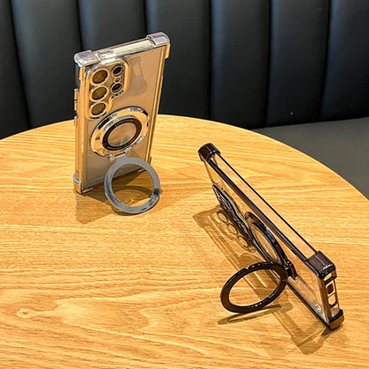 Two phone cases with ring stands on a wooden table