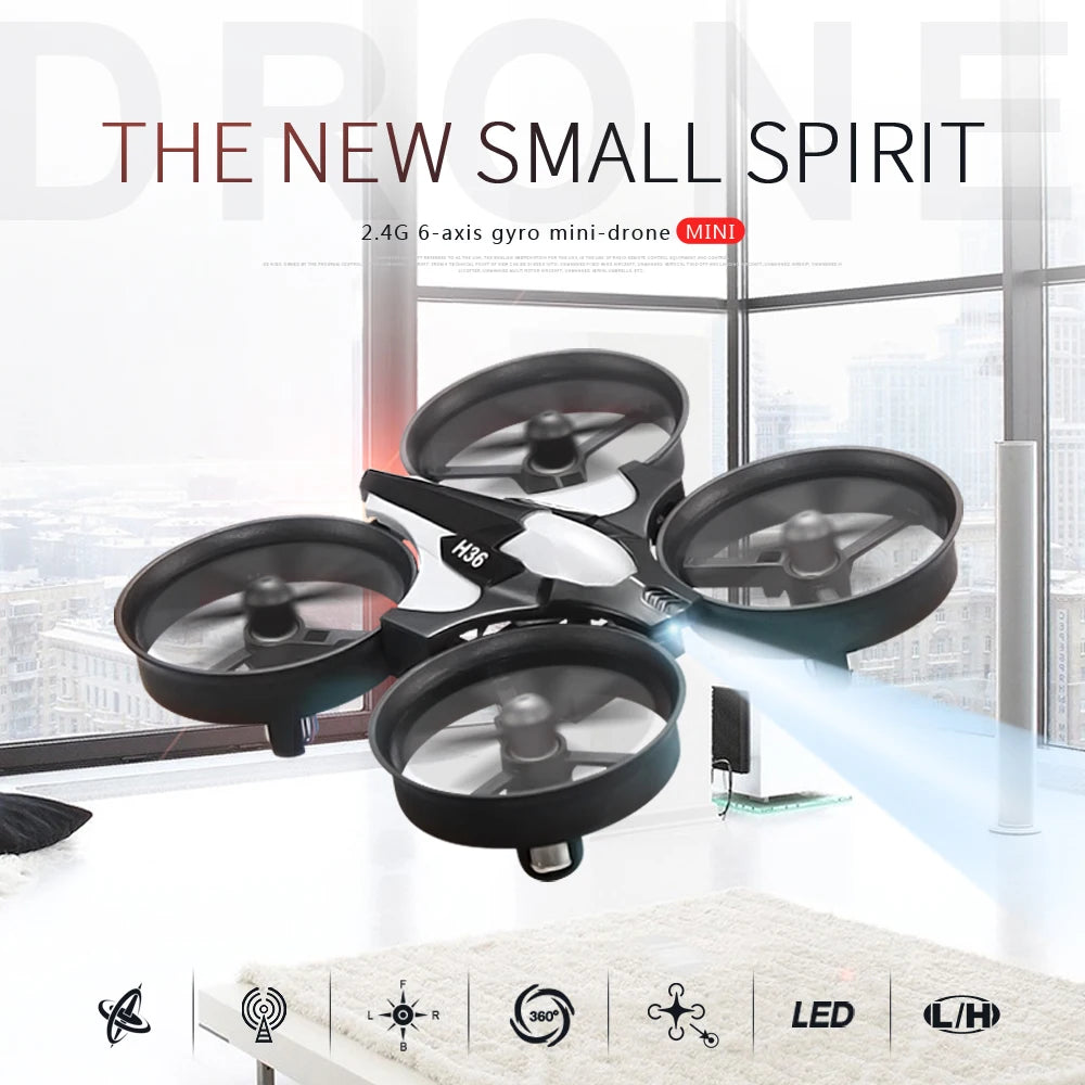 Black mini-drone with transparent propellers on a white surface with a cityscape background