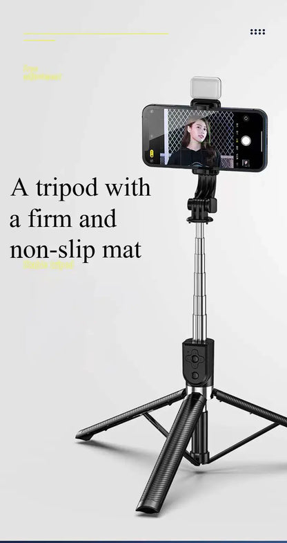 Black tripod with smartphone holder on a light gray background