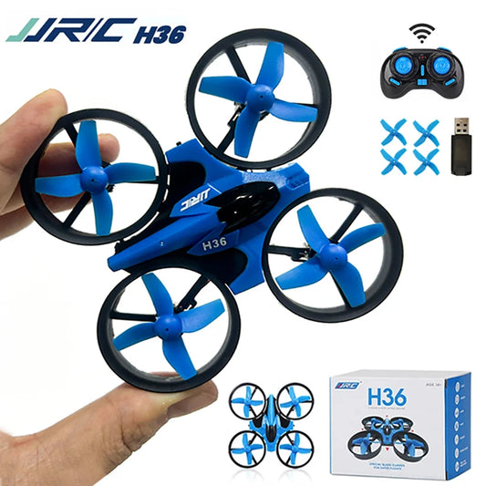Blue and black JJRC H36 drone held by a hand with remote control and box in the background.