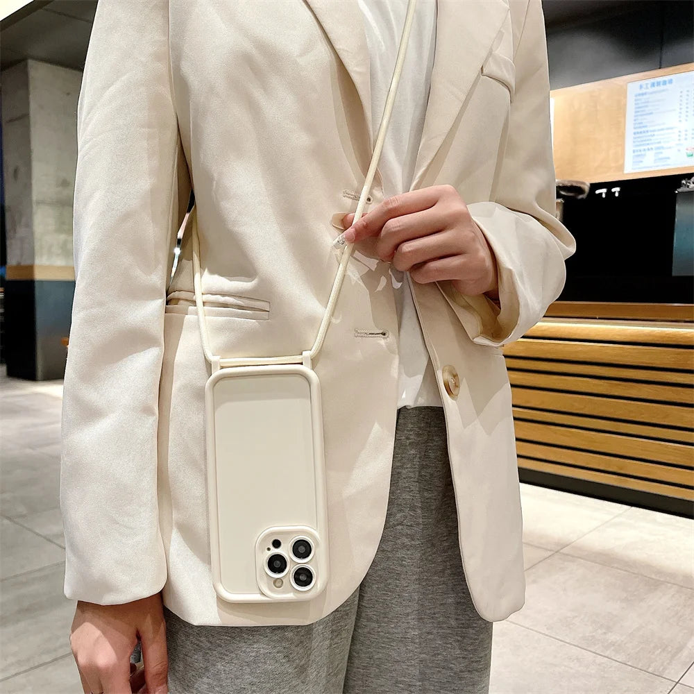 Person wearing a beige blazer with a phone case attached to it, standing in an indoor setting.