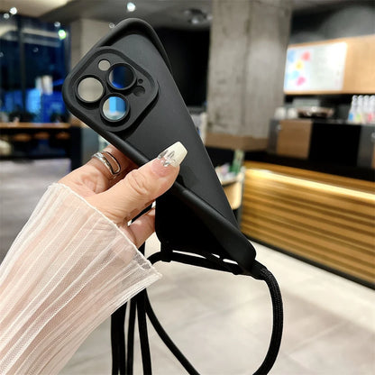 Person holding a black phone case with a blurred indoor background