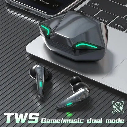 Wireless earbuds with charging case placed on a laptop keyboard, featuring the text 'TWS Game/Music Dual Mode'
