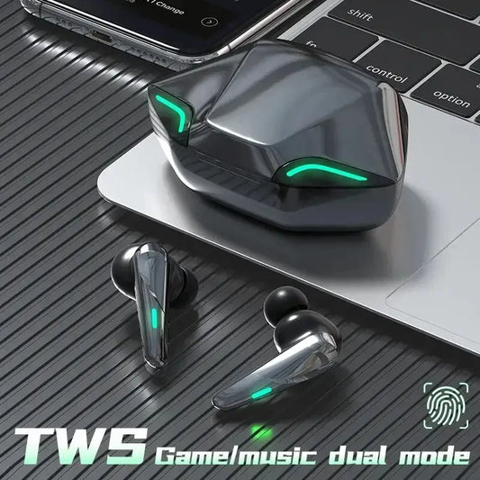 Wireless earbuds with charging case placed on a laptop keyboard, featuring the text 'TWS Game/Music Dual Mode'
