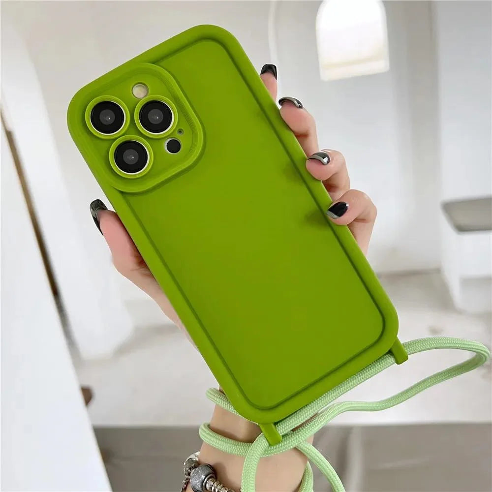 Green phone case with a strap held by a hand against a neutral background