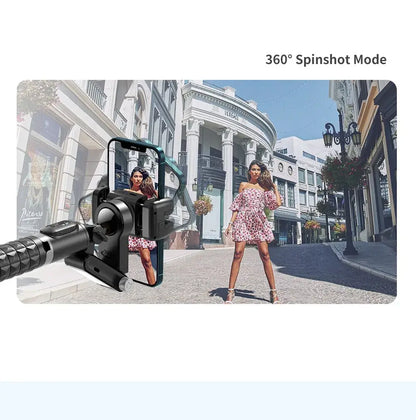 Woman in a dress standing on a city street with a gimbal camera showing 360° spinshot mode.