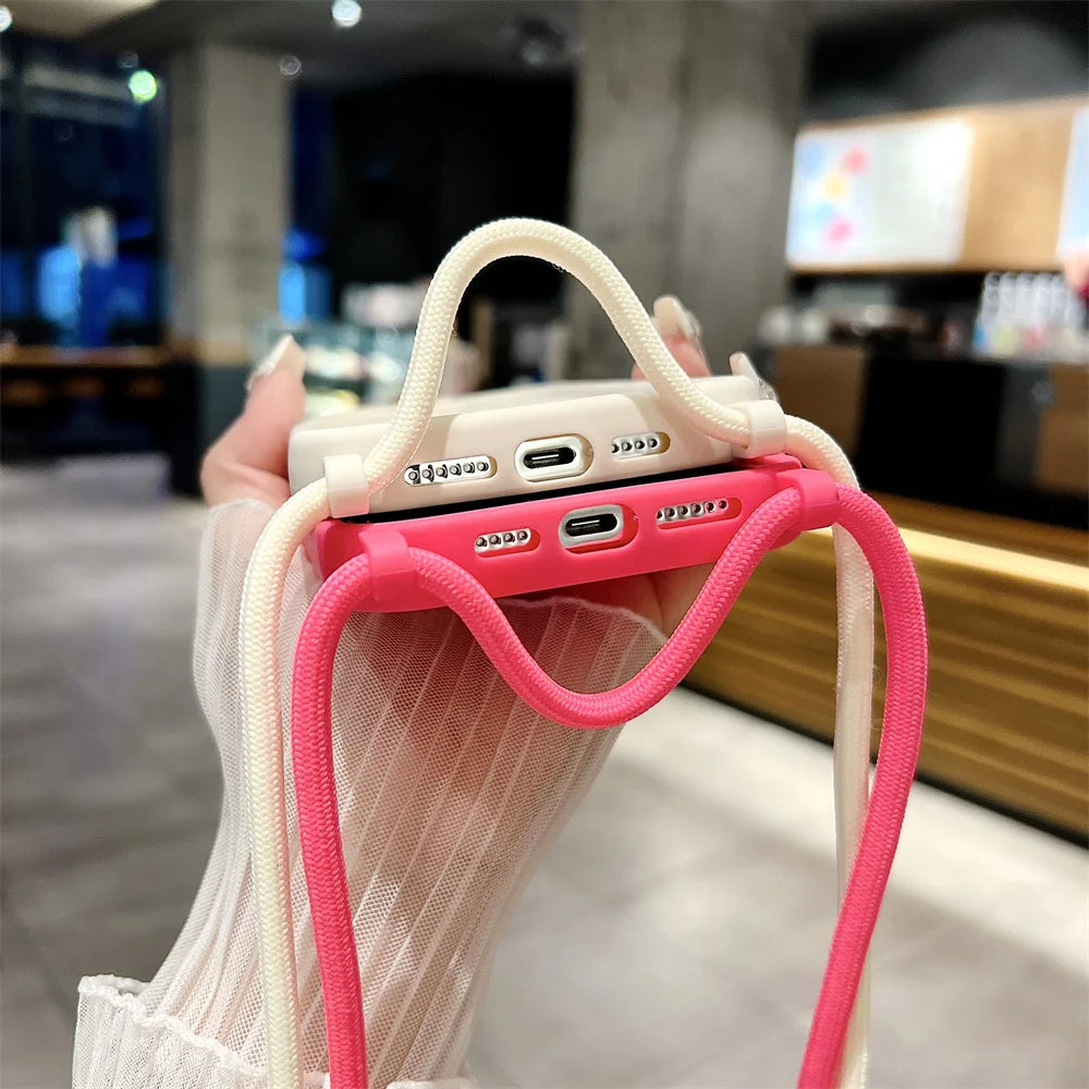 Phone case with pink handle held by a person in an indoor setting