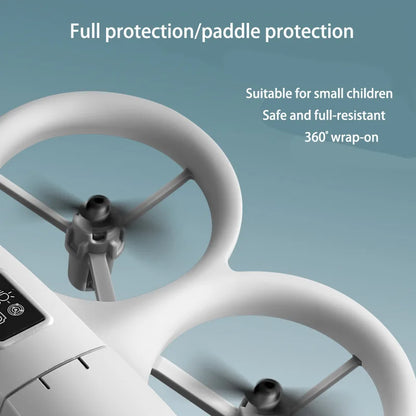 Close-up of a white drone with protective coverings on a light blue background, featuring text about protection and suitability for small children.