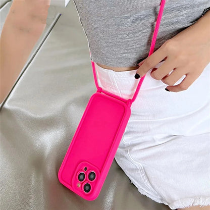 Pink phone case with a strap held by a person on a neutral background