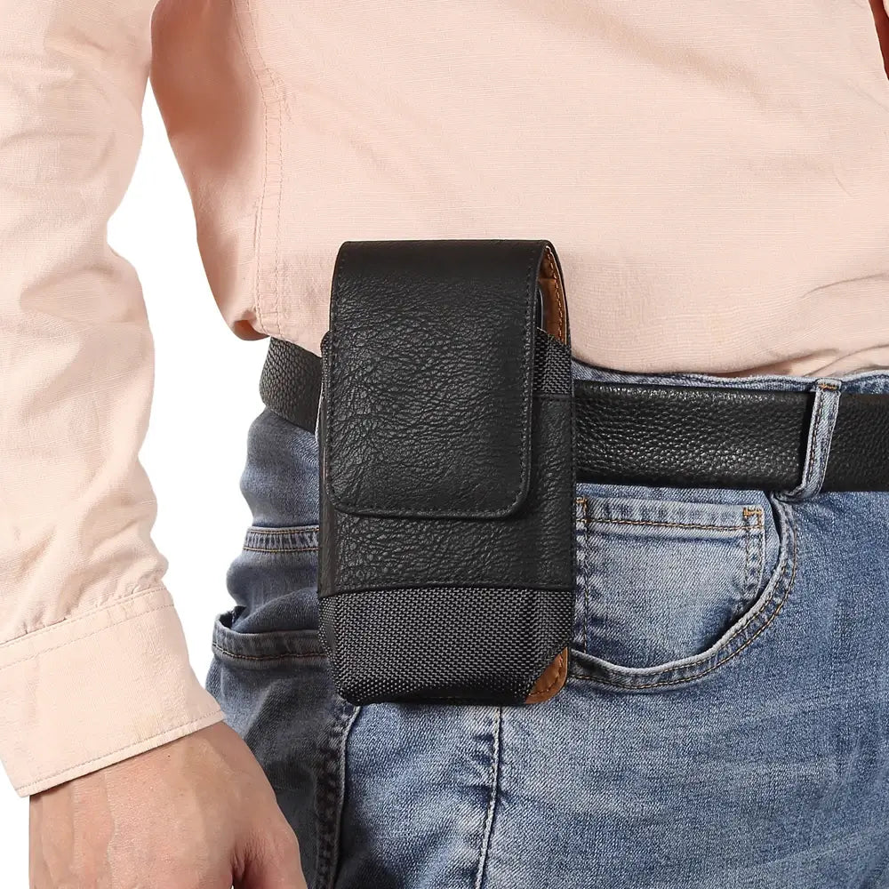 Person wearing a black leather phone holster on a belt
