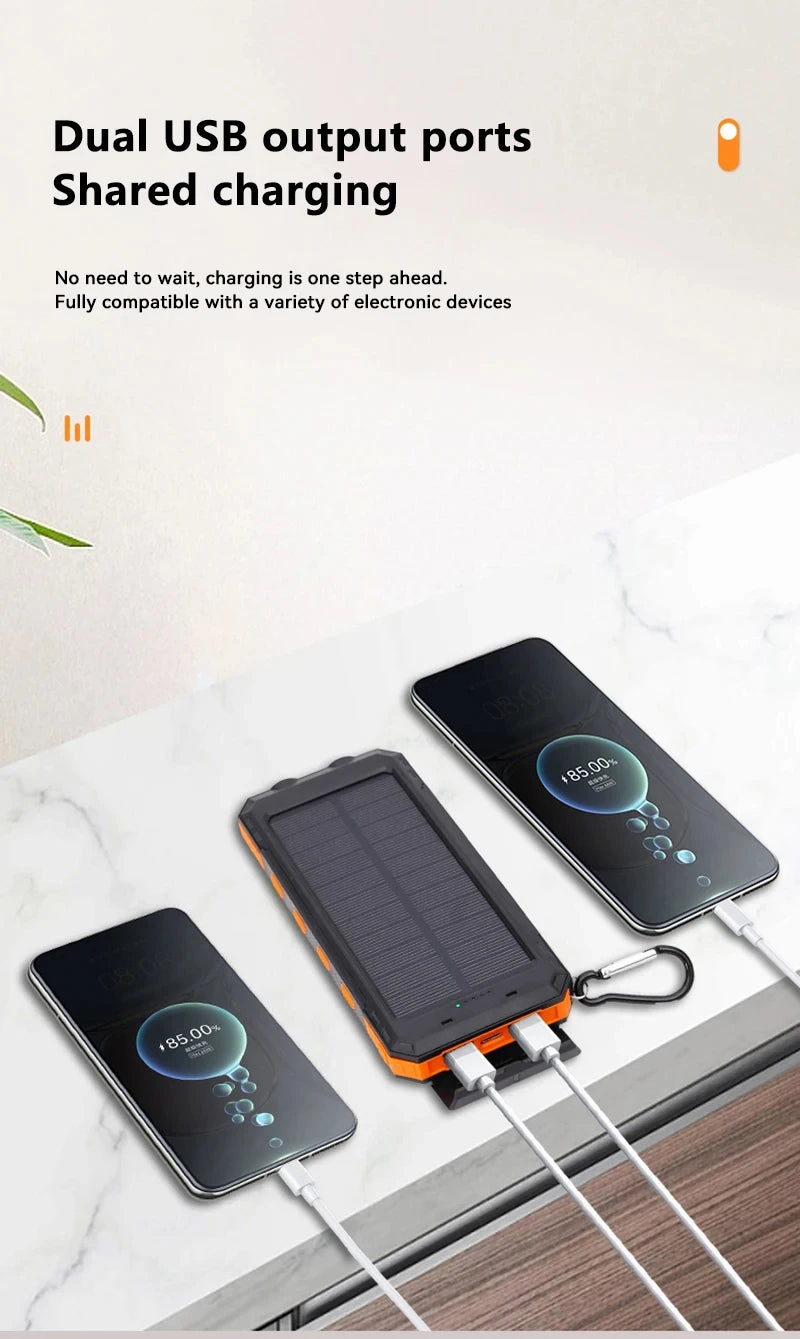 Solar power bank with dual USB output ports charging two smartphones on a marble surface.