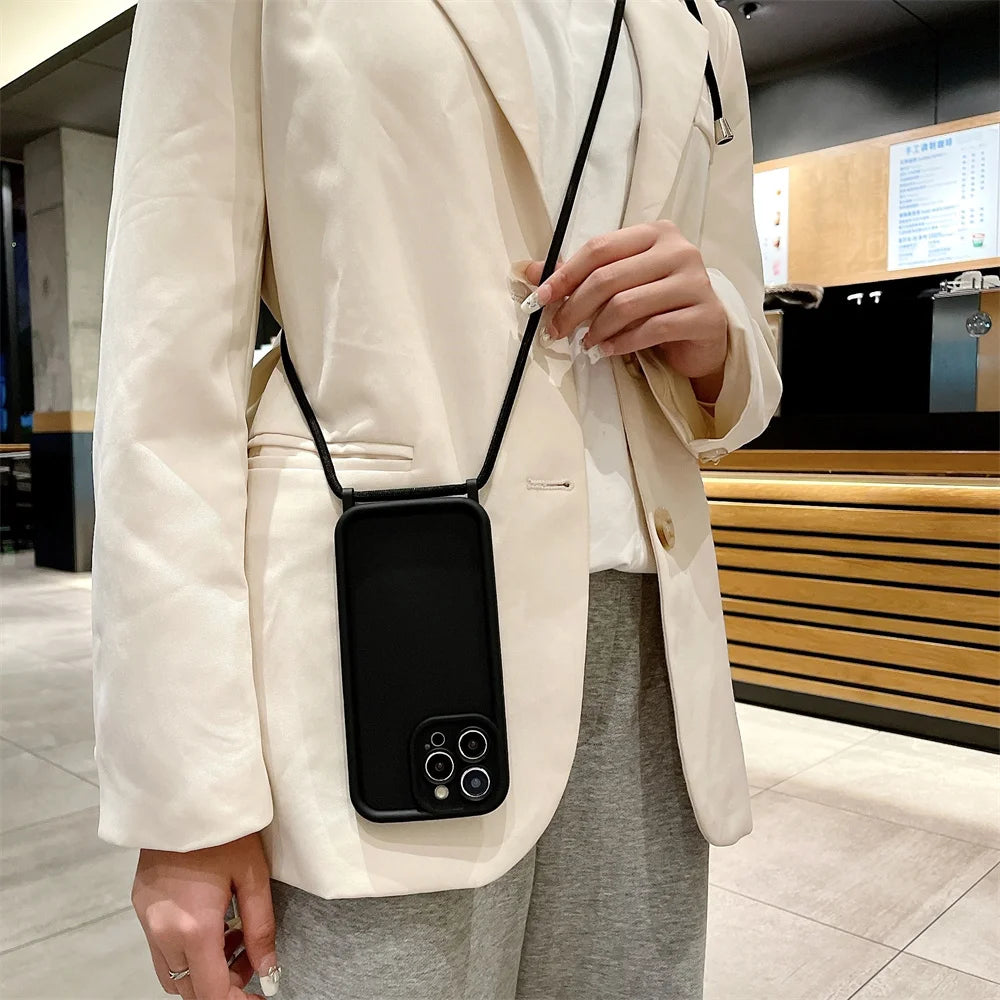 Person wearing a white coat with a black phone case on a strap over their shoulder.