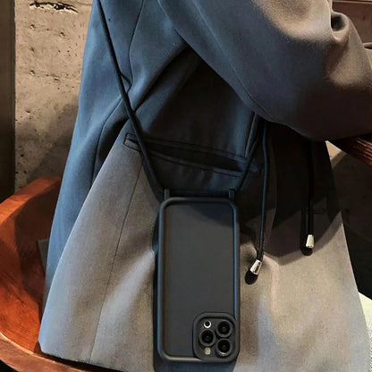 Person wearing a coat with a phone case attached to the pocket