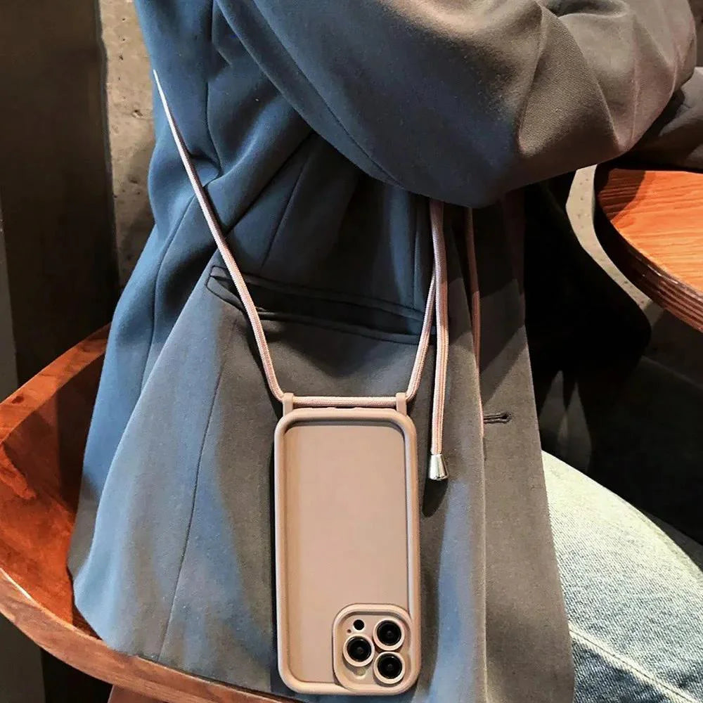 Person wearing a beige phone case with a strap over a blue coat.