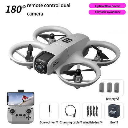 Gray drone with remote control, battery, and accessories on a white background